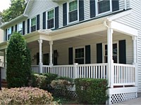 <b>Colonial porch columns with white vinyl railing and composite deck boards with white fascia wrap and white lattice</b>